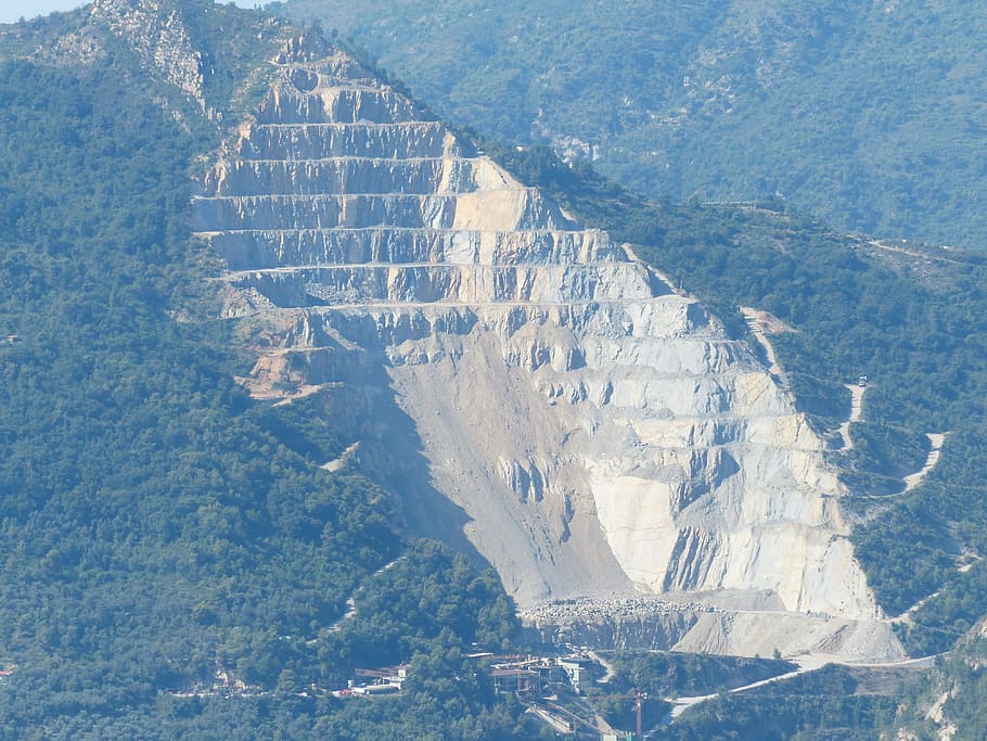 landscape photo of green mountains, quarry, removal, limestone