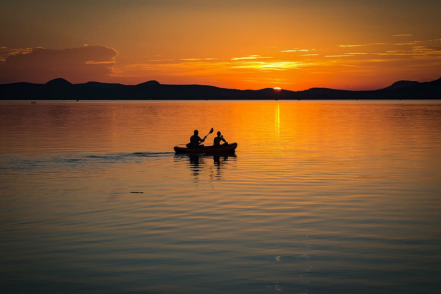 silhouette photography of two person on boat sailing during golden hour, HD wallpaper