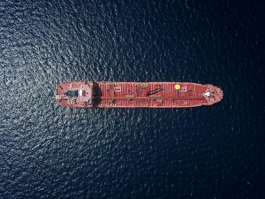 aerial photography of tanker ship, top view photo of red oil ship on water at daytime