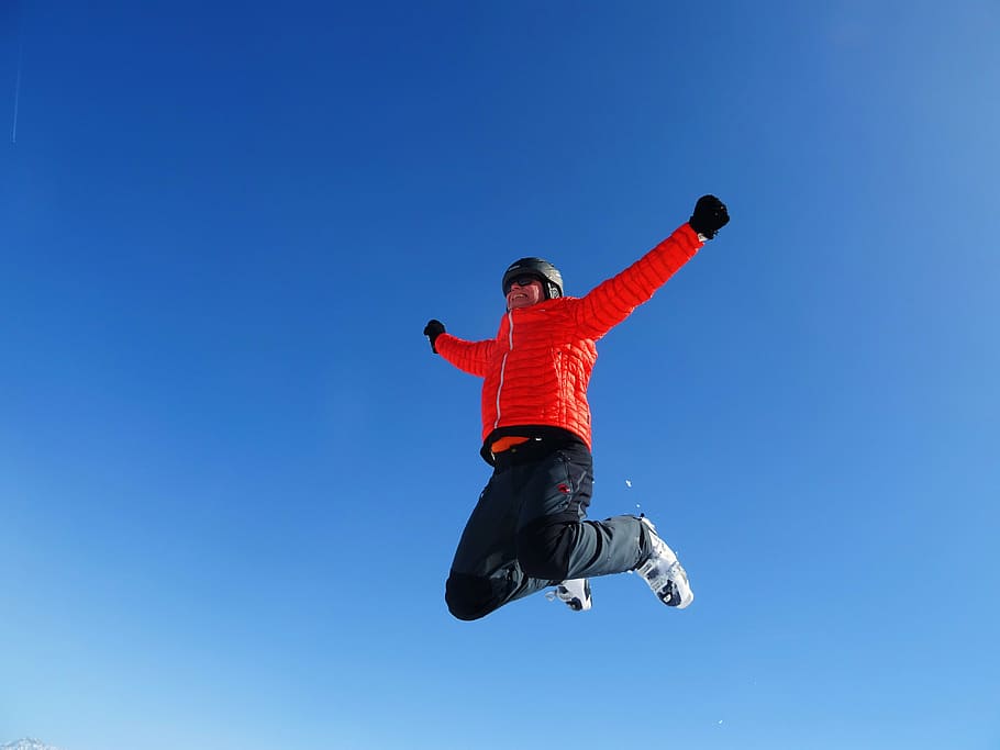 person in red bubble jacket jumping during daytime, skiing HD wallpaper