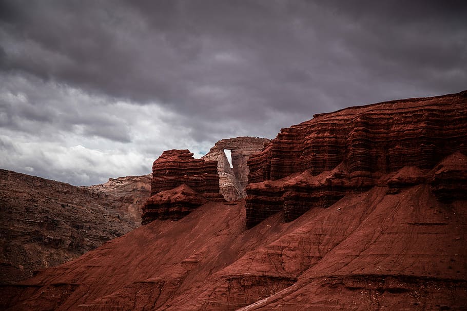 rock formation under cumulus clouds, brown rock formation under gray clouds HD wallpaper