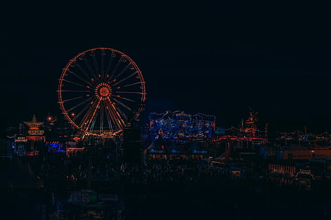 lighted Ferris wheel beside building, Cityscape photo of amusement park during nighttime HD wallpaper