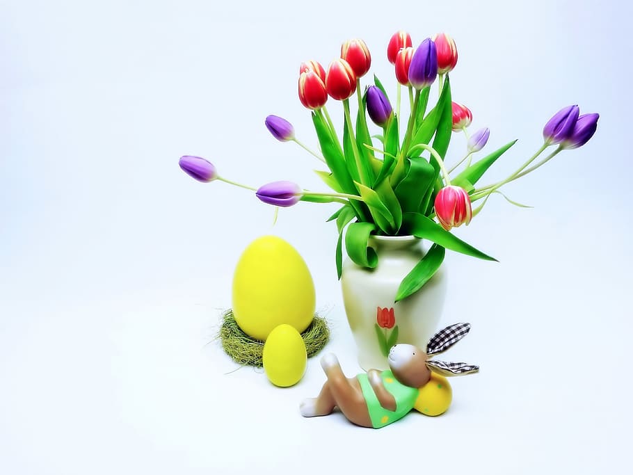 red and purple tulip flowers in white ceramic vase beside yellow egg toys HD wallpaper