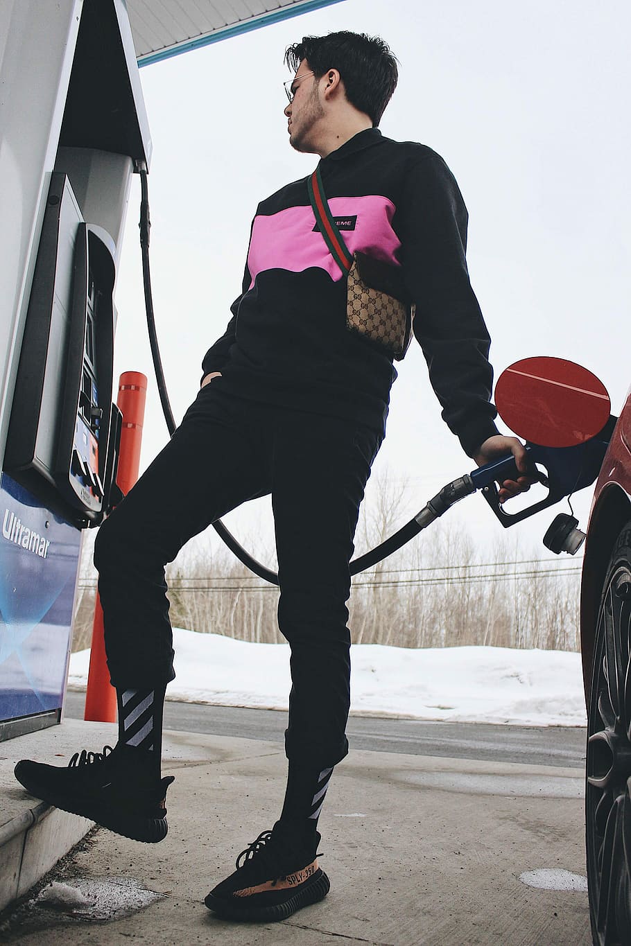 HD wallpaper: man refilling gas on red car on gas station, yeezy