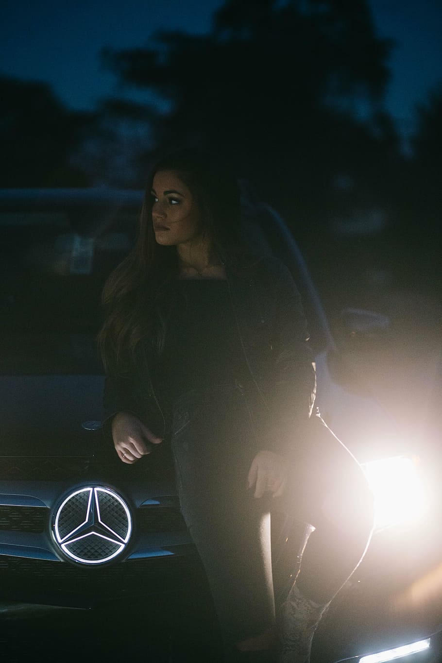 woman leaning on black Mercedes-Benz vehicle at daytime, car