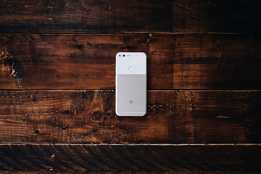 flat lay photography of white Google Pixel Android smartphone, very silver Google Pixel 2 XL smartphone on brown surface, HD wallpaper