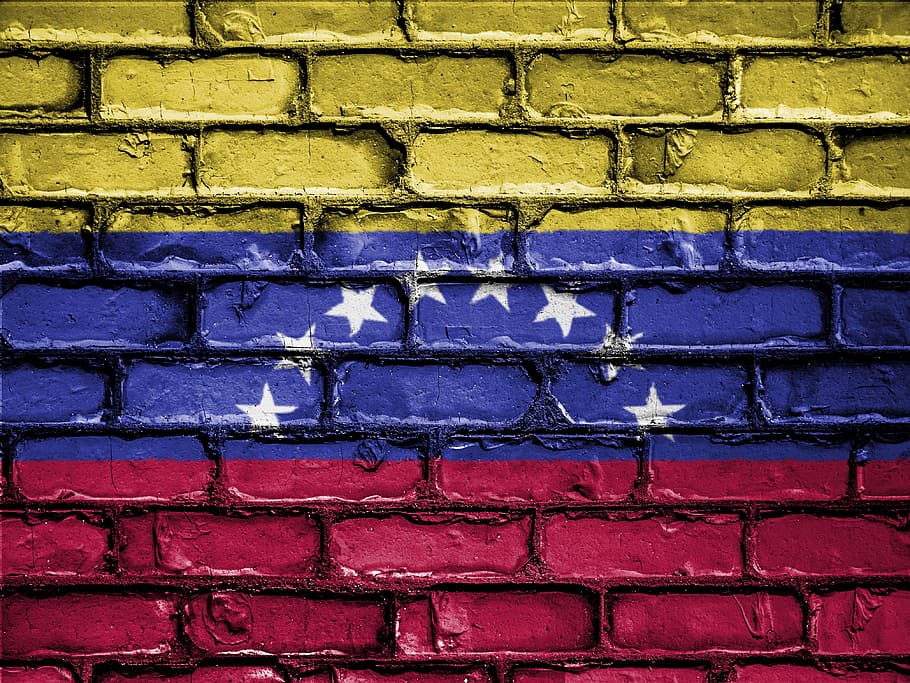 yellow, blue, and red flag with white stars painted on brick wall, HD wallpaper