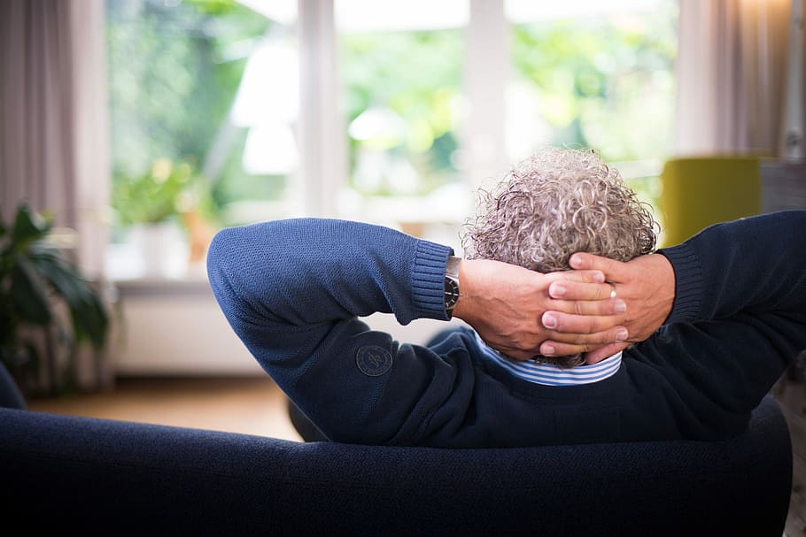 man in blue sweater sitting on blue sofa, male, hands, one person HD wallpaper