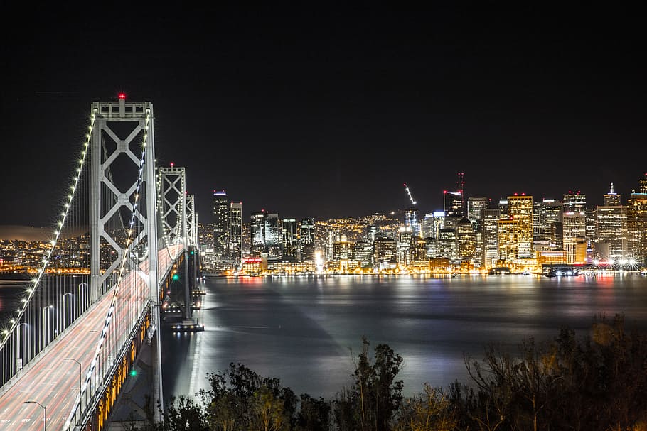 bridge beside city, Brooklyn Bridge during nighttime, aerial photo HD wallpaper