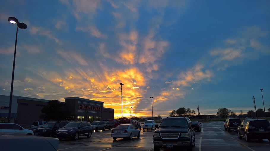 sunset, light, rays, parking, cars, sky, transportation, cloud - sky HD wallpaper