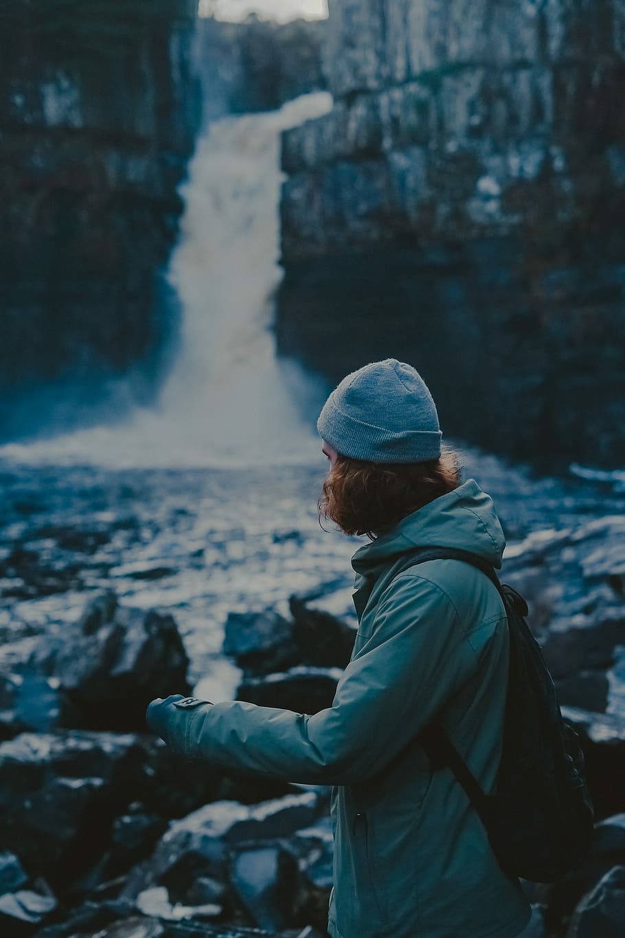 woman wearing coat near falls, person standing on rock, waterfall HD wallpaper