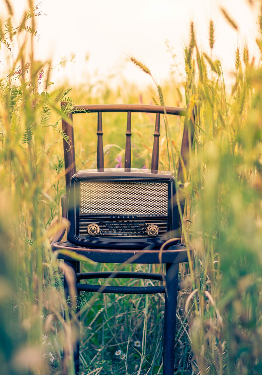 black transistor radio in the middle of the field, black transistor radio on brown wooden chair at the middle of field, HD wallpaper