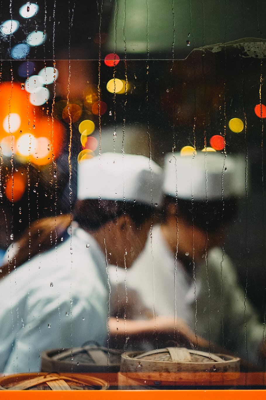 two persons in white hats taken from glass frame with waterdrops, chefs preparing dimsum meal with bokeh light background HD wallpaper
