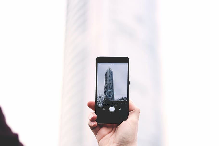 person taking photo of building, cellphone, holding, mobile HD wallpaper