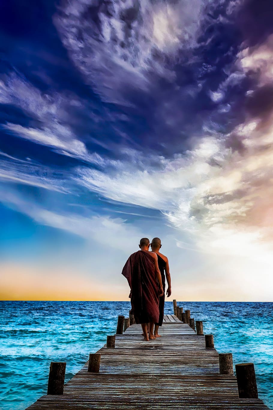 two monks walking on wooden dock, water, sunset, sea, sky, ocean