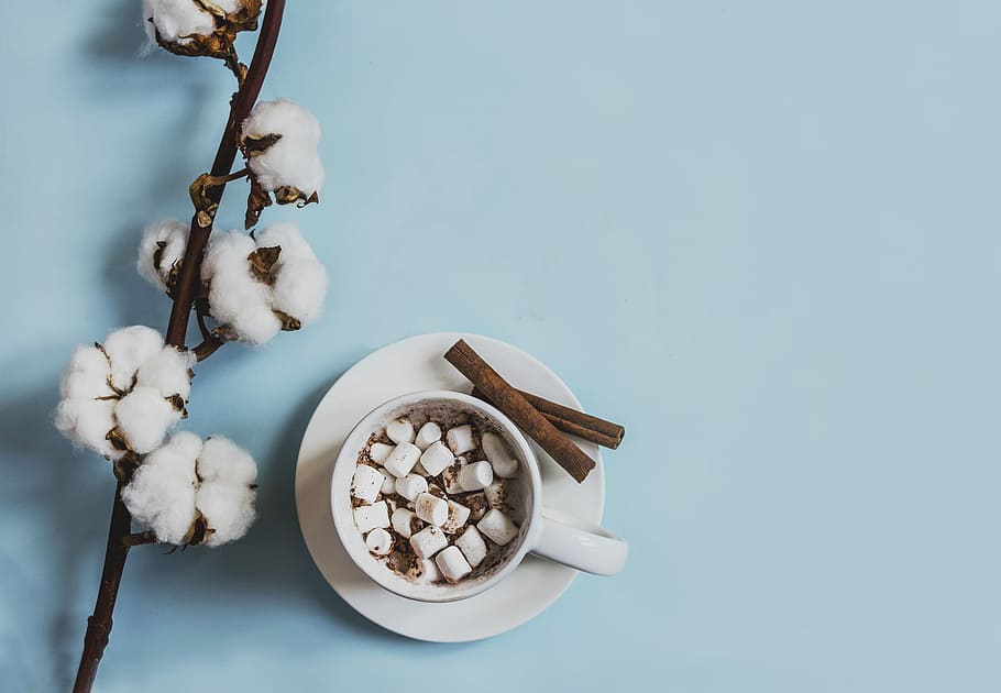 white ceramic mug filled with marshmallows beside cinnamon sticks placed on round white ceramic saucer near white cuttons, top-view photography of marshmallow filled white ceramic mug on round white ceramic saucer, HD wallpaper