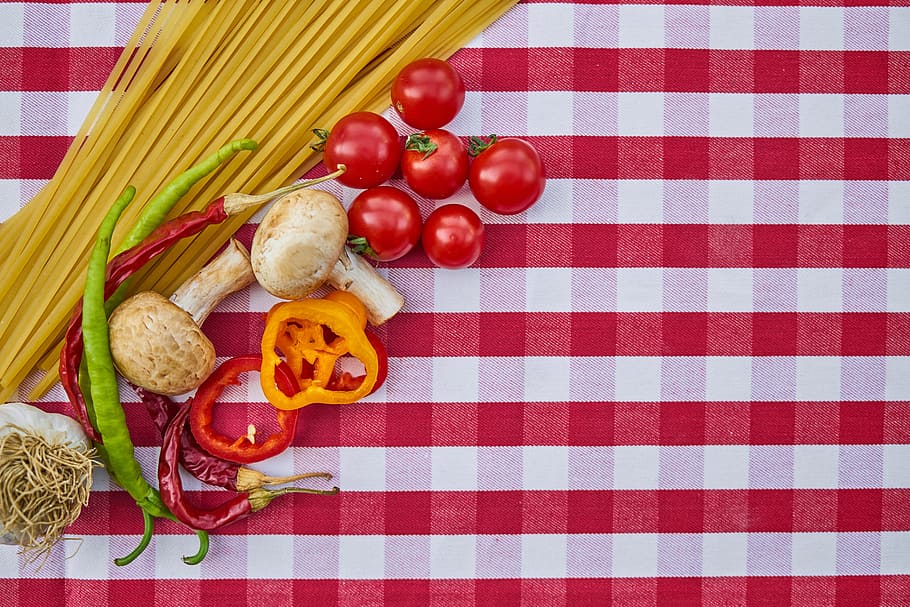 red tomatoes on white and red tablecloth, pasta, spaghetti, food