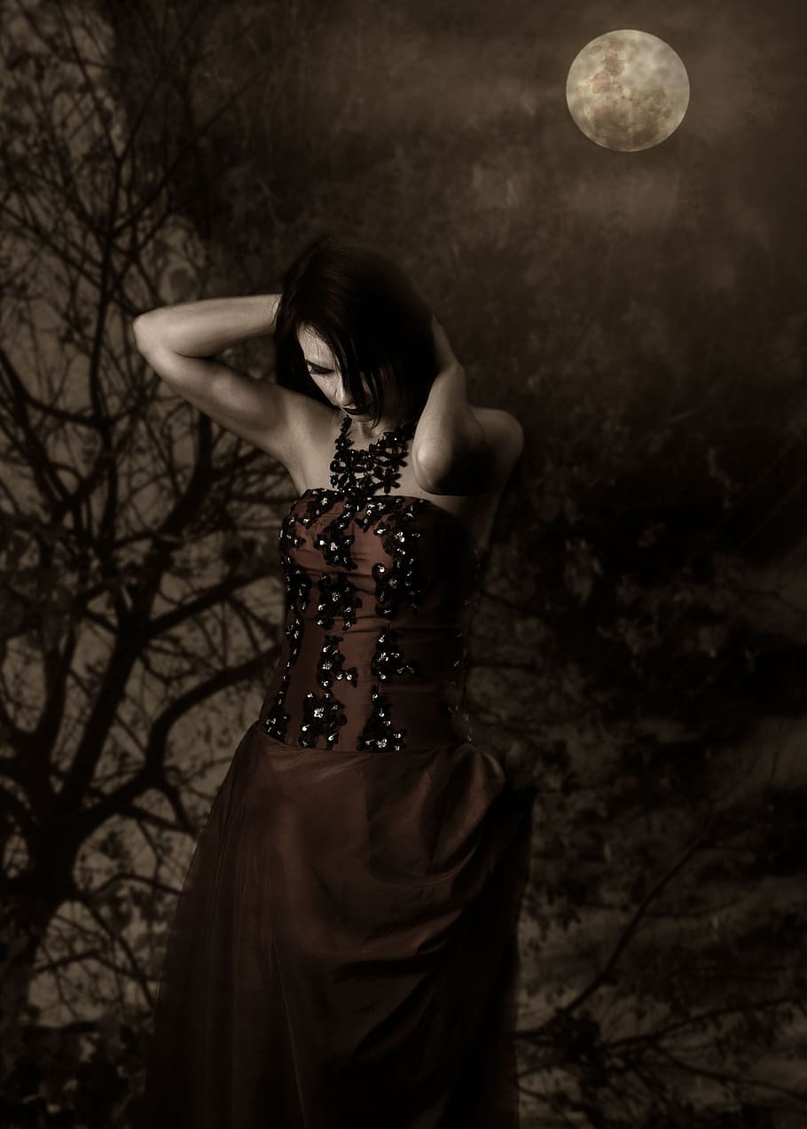 woman wearing brown and black dress holding her head under full moon HD wallpaper
