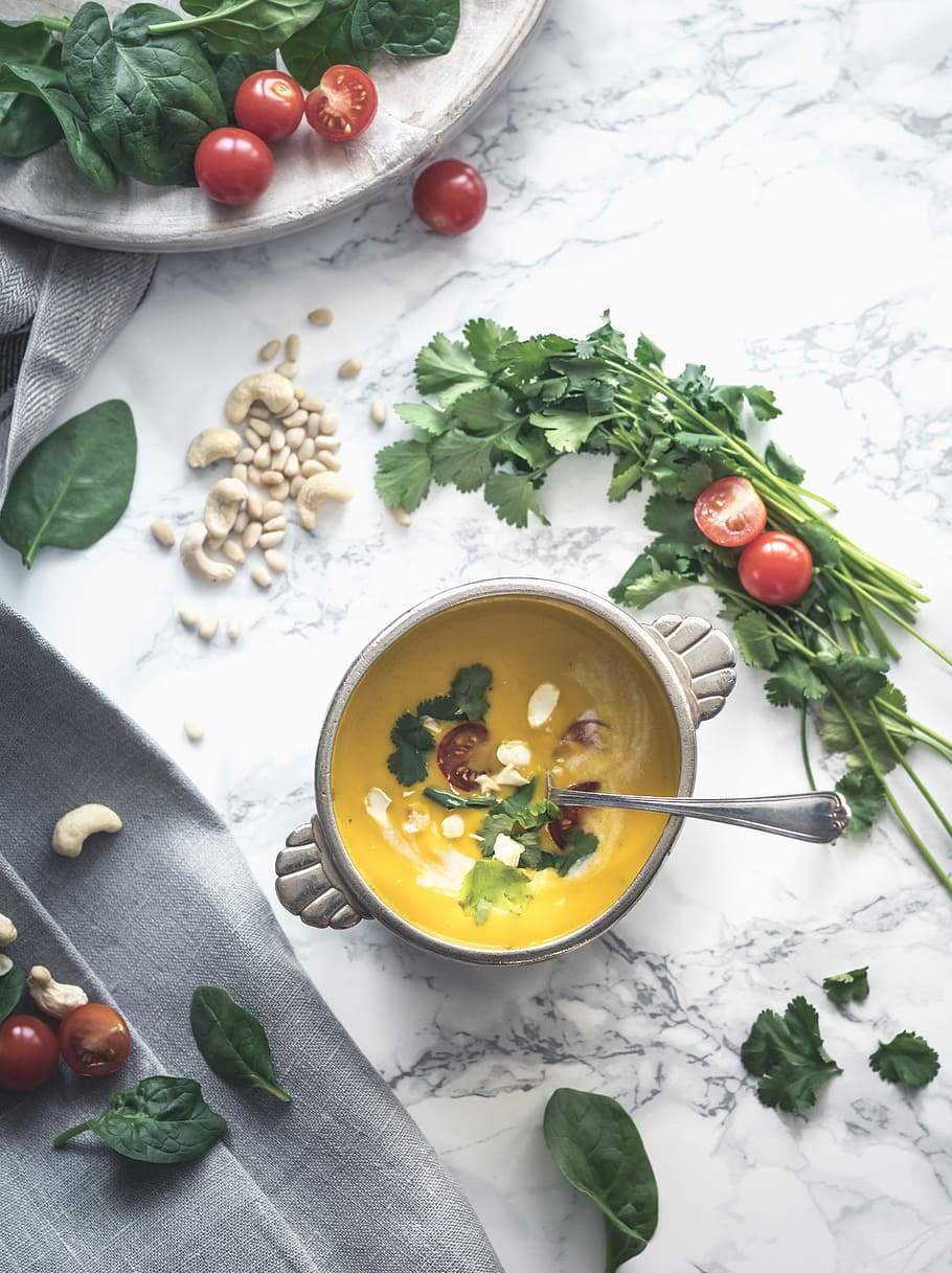 green leafy vegetable topped yellow cream soup in round gray ceramic bowl, flat lay photograhy of gray ceramic bowl filled with yellow soup, HD wallpaper