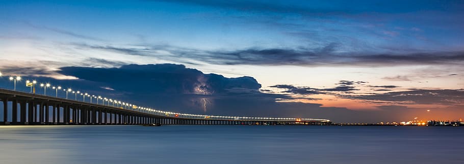 lampposts lighted up on bridge, sunset, sea view, architecture HD wallpaper