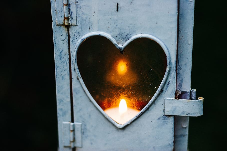 turned on candle lantern, candle reflected on heart mirror with white frame HD wallpaper