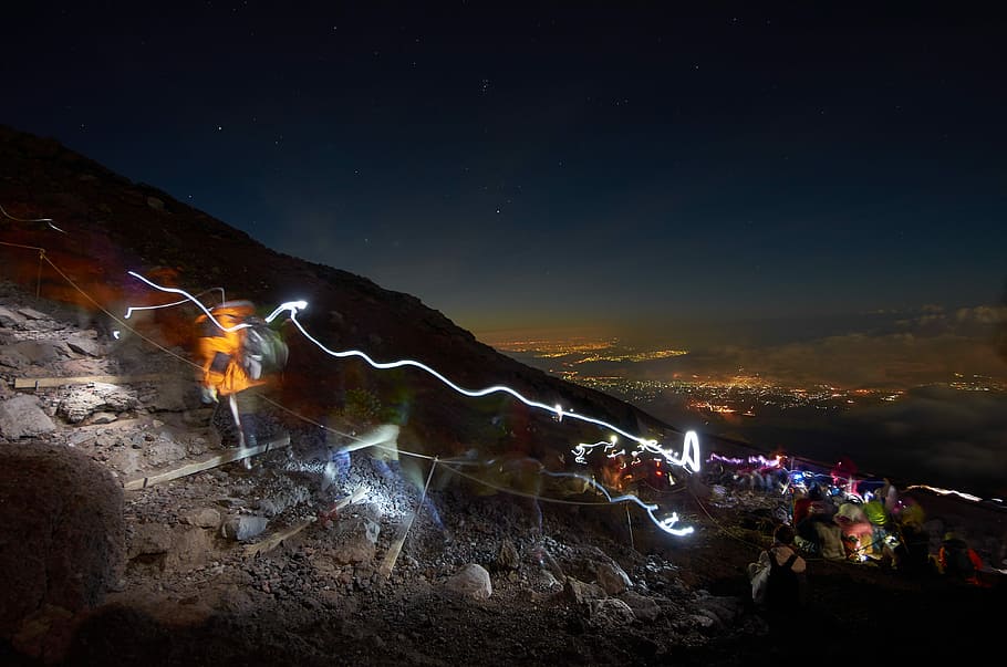 assorted-color lights on mountain at nightime, time lapse photography of lights on mountain HD wallpaper