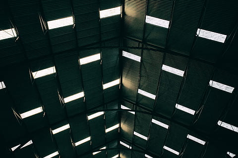Wide angle shot of light patterns coming through the roof of a large building at Chatham Dockyard in Kent, England HD wallpaper