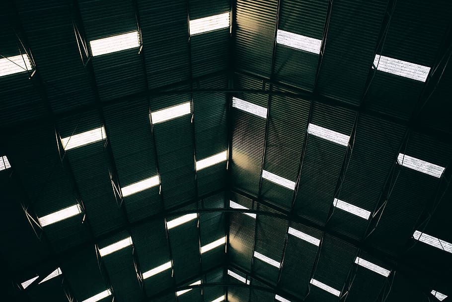 Wide angle shot of light patterns coming through the roof of a large building at Chatham Dockyard in Kent, England HD wallpaper