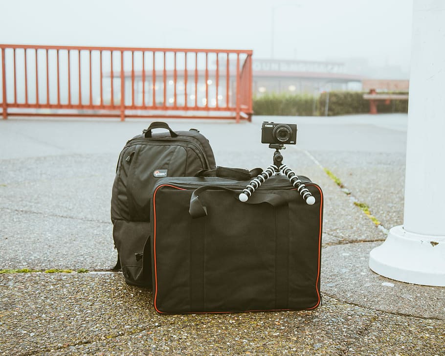 HD wallpaper: camera mounted on tripod on top of luggage bag, black camera with tripod on black bag outdoors - Wallpaper Flare