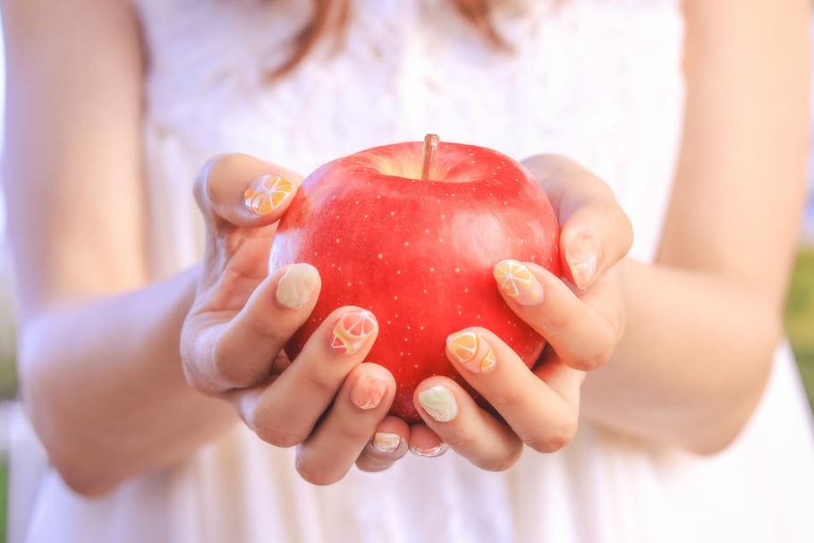 woman holding red apple fruit, women, apple - Fruit, human Hand HD wallpaper