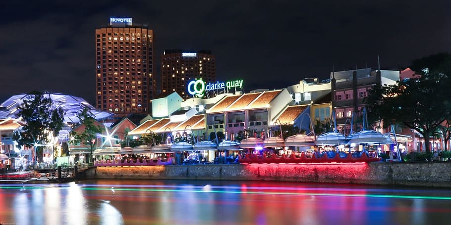 lighted building beside body of water at nighttime, clarke quay