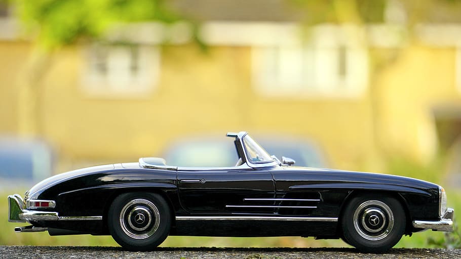 focus photography of black convertible coupe die-cast scale model