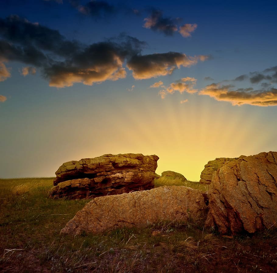 landscape photography of beige boulders under gray sky during golden hour HD wallpaper
