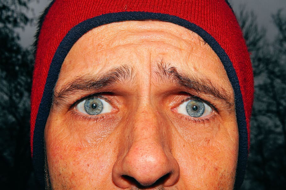 closeup photo of a man wearing blue and red bubble cap, face HD wallpaper