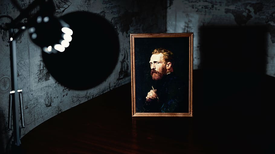man wearing black coat painting with brown wooden frame near turned-on lamp HD wallpaper