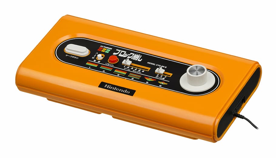 close-up photography of rectangular orange and black Nintendo electronic device HD wallpaper