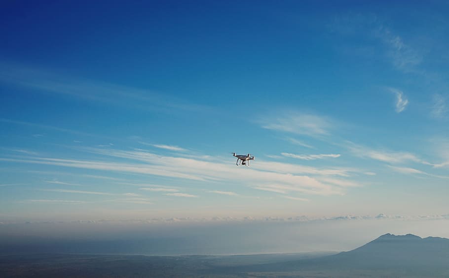 white quadcopter drone on air, drone in sky, blue, flying, mountain HD wallpaper