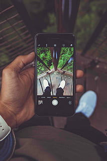 person holding iPhone 6 with black case, person holding black iPhone while using camera HD wallpaper
