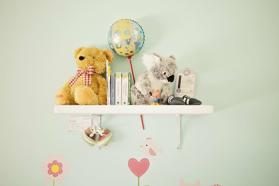 bear and kuala plush toys on white wooden floating shelf, nursery decoration