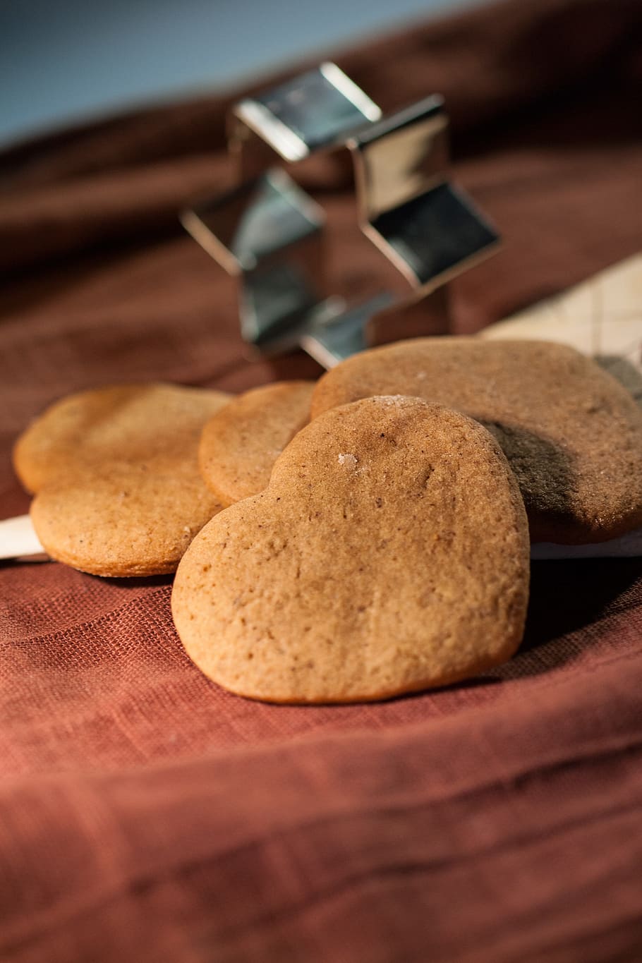 heart baked cookies beside gray cookie cutter on red apparel HD wallpaper