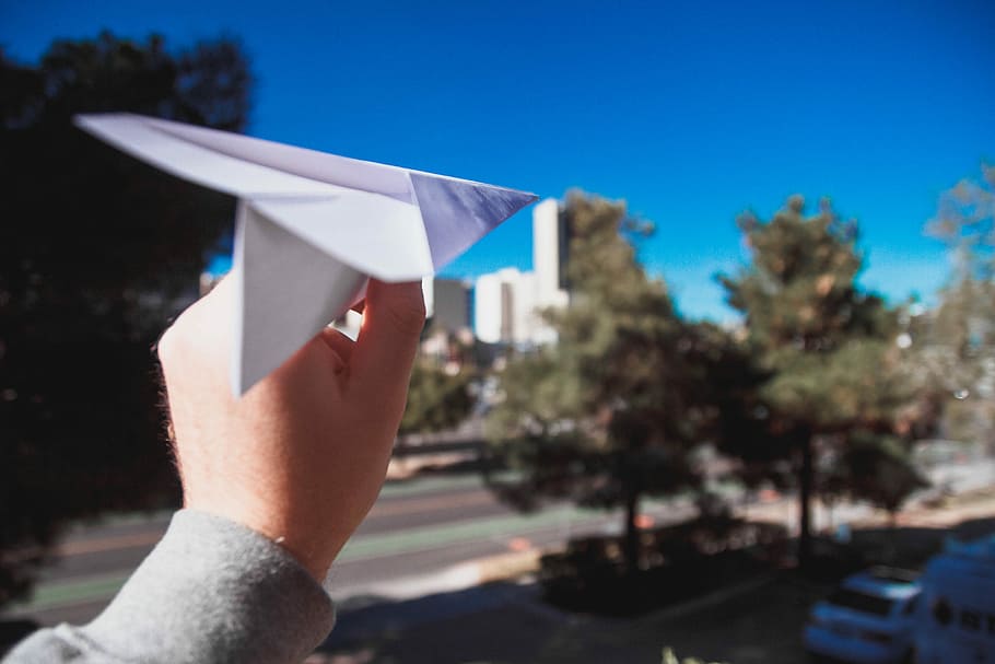 person holding paper plane, person holding white paper airplane, HD wallpaper