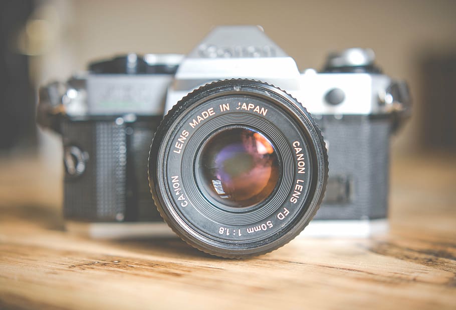 gray and black single-lens reflex camera on brown surface, canon HD wallpaper