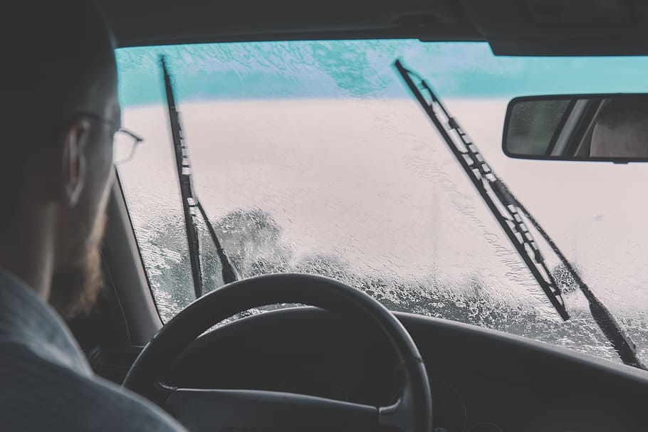 man driving car during rainy day with wipers wiping water, windshield, HD wallpaper