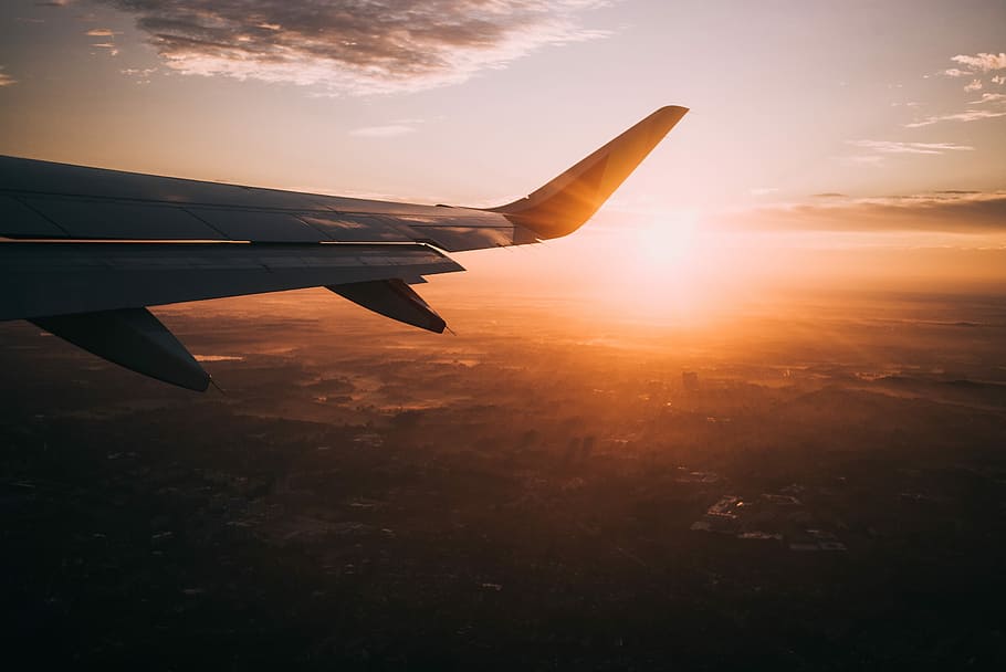 airplane on sky during golden hour, golden hour photography of aircraft wing and landscape HD wallpaper