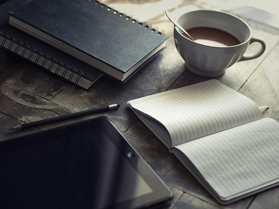 black tablet computer near opened notebook, diary, ipad, to write HD wallpaper