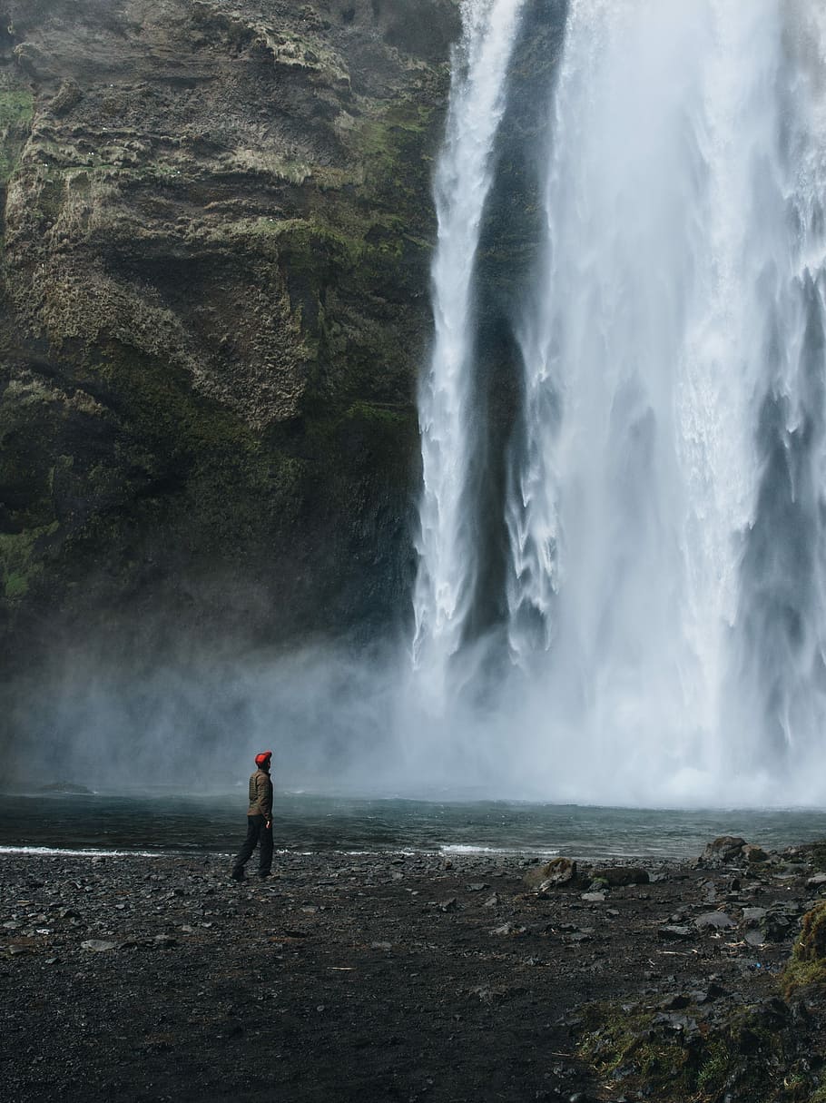 man near waterfalls, person standing near waterfalls, winter HD wallpaper