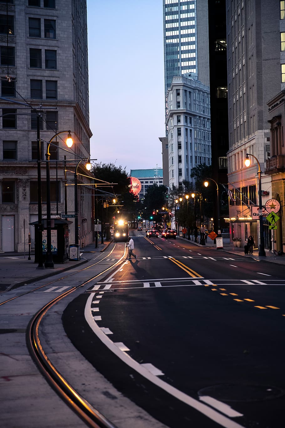 person walking on pedestrian lane, person crossing on highway between buildings HD wallpaper