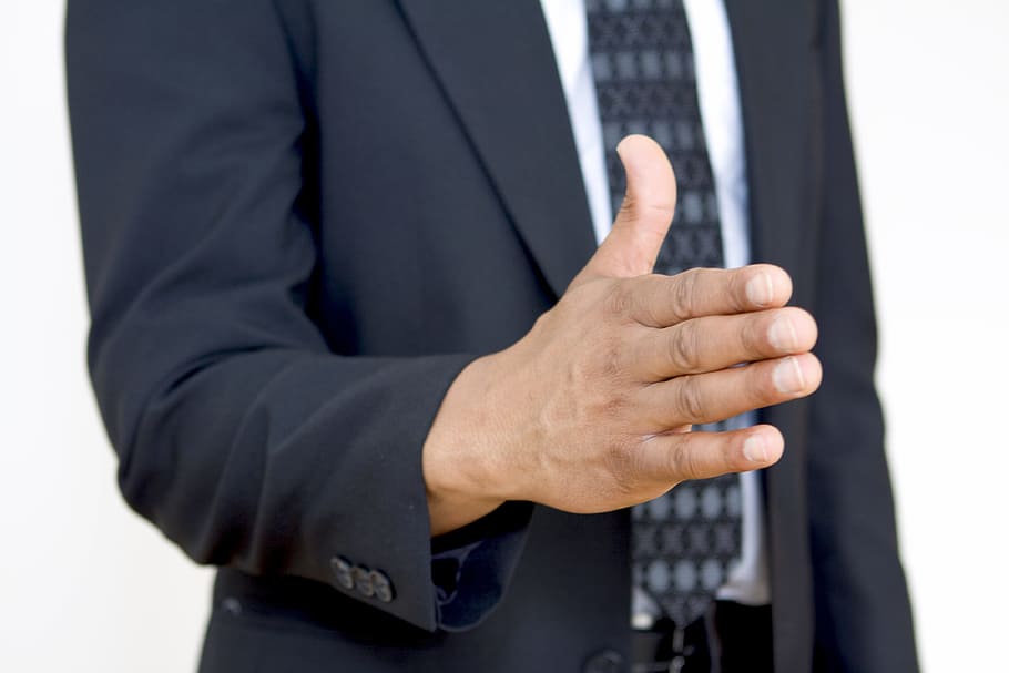 man standing wearing black suit, hand, business, gesture, welcome HD wallpaper