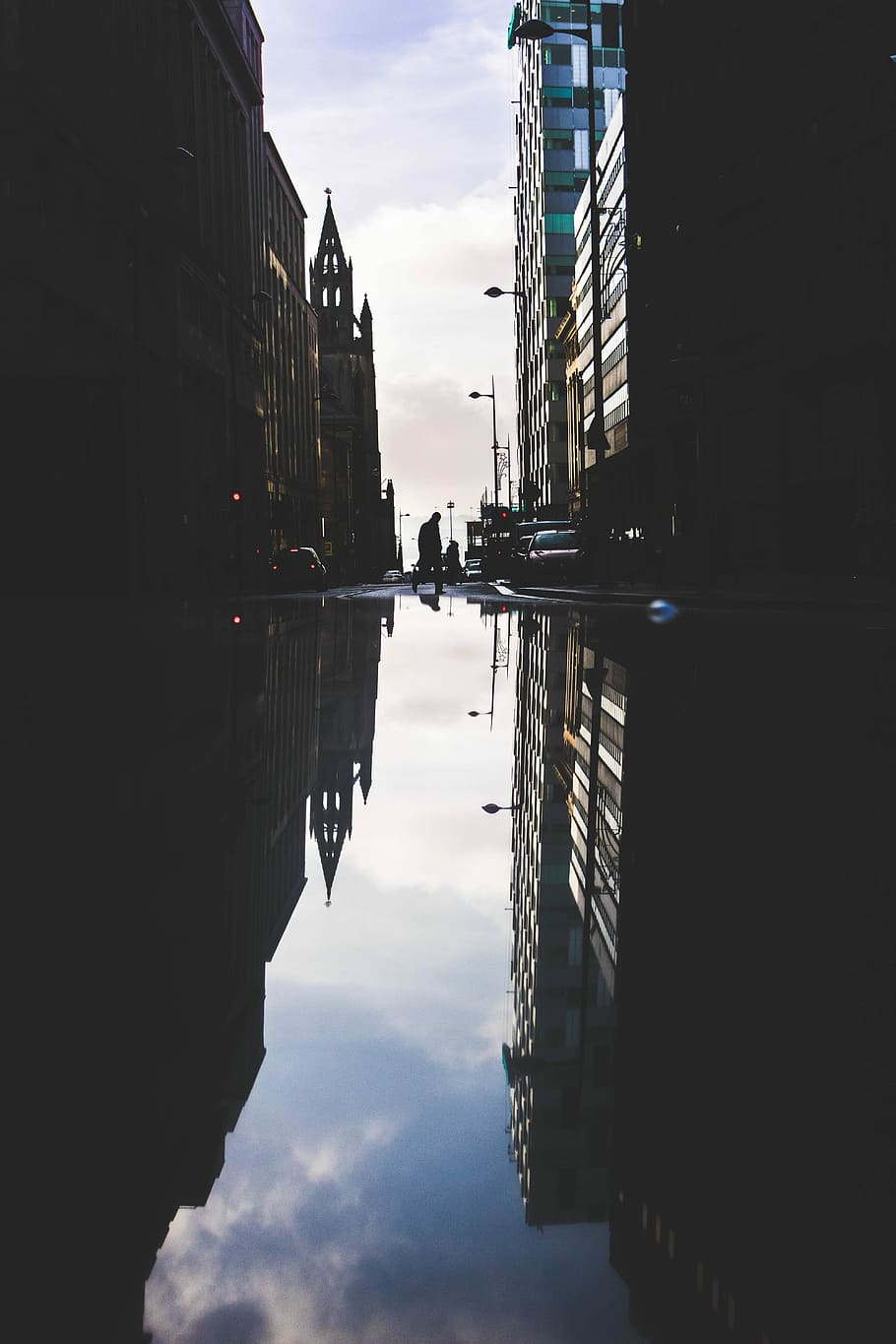 landscape photography of high-rise buildings with reflection on the water, silhouette of person standing between building HD wallpaper