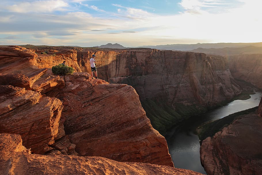 person standing on top of canyon during daytime, person standing on top of cliff HD wallpaper